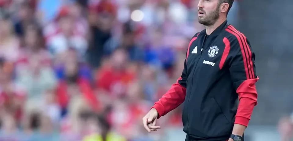 Coach on sidelines during football match
