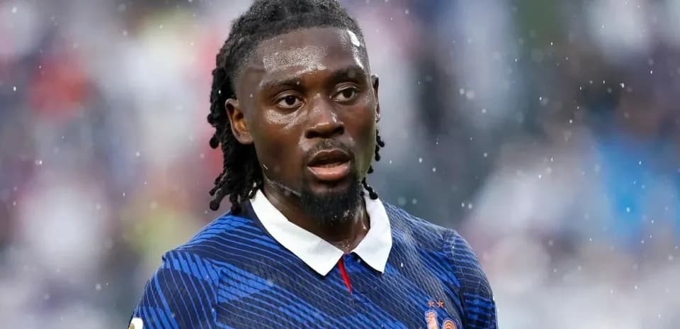 Player in blue jersey during a rainy match