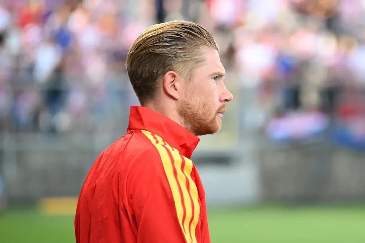 Player in red tracksuit during match warm-up
