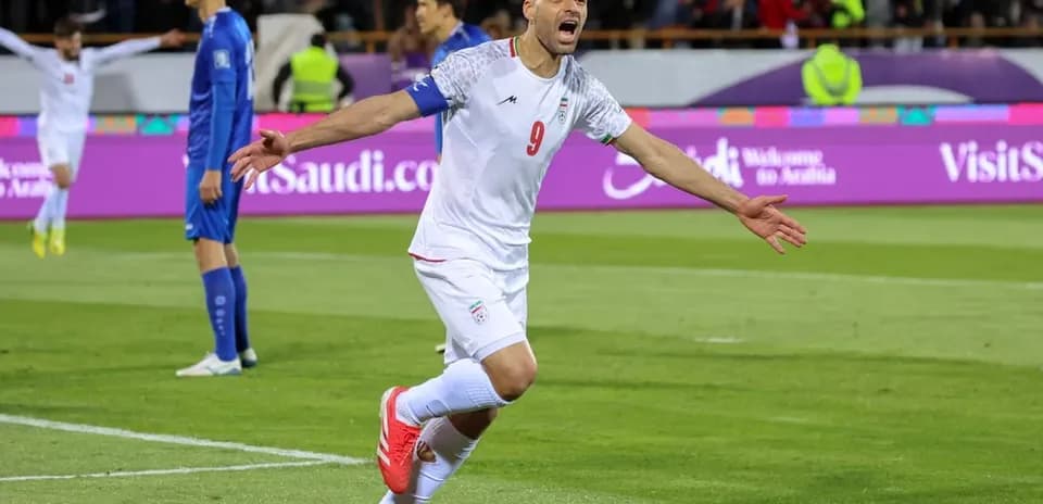 Iran player celebrating goal during match