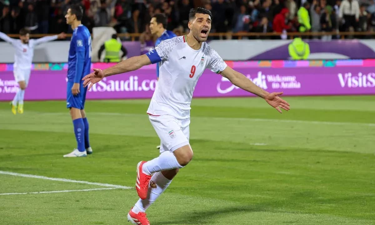 Iran player celebrating goal during match