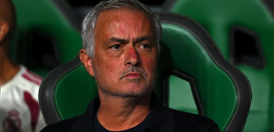 Manager seated on bench during match observation