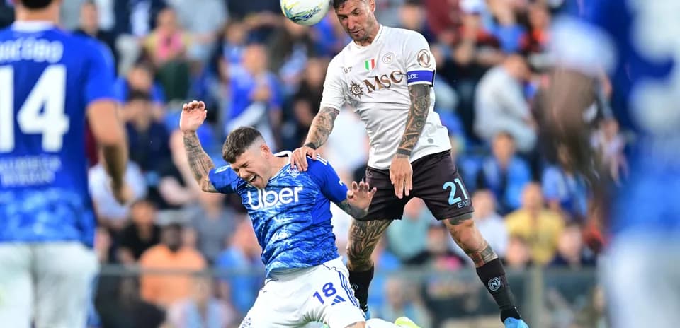 Napoli player challenging Como player for the ball