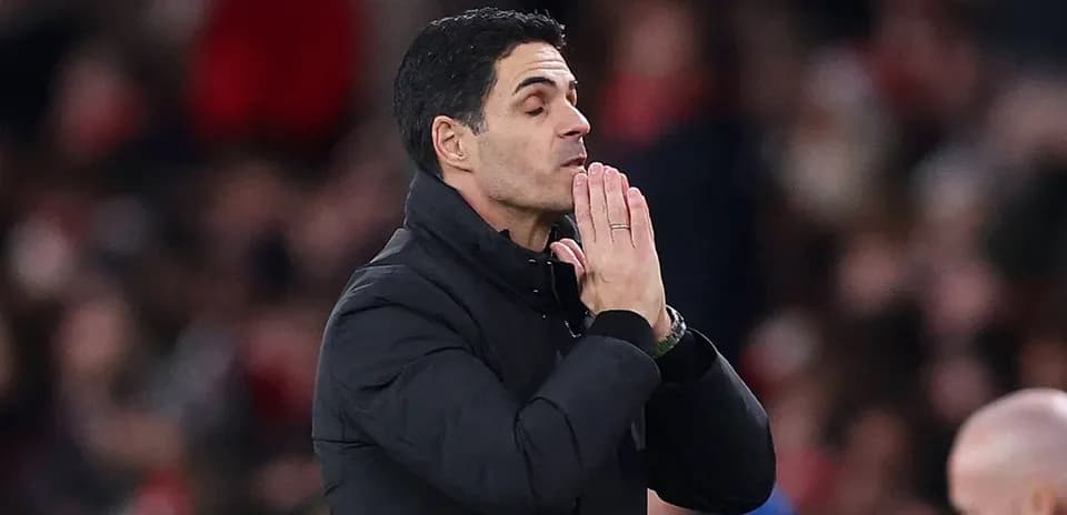 Coach with hands clasped during a match