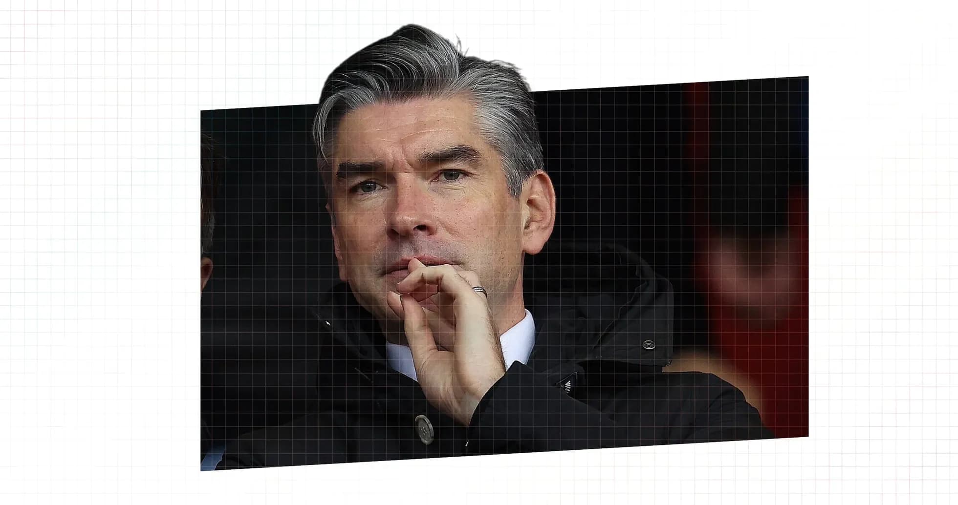 Man in black coat watching from the stands