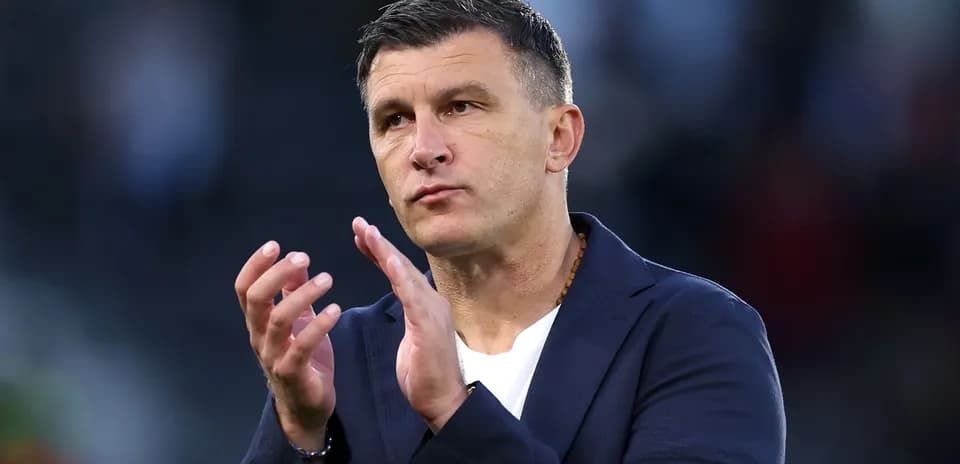 Coach gesturing during match celebration or discussion