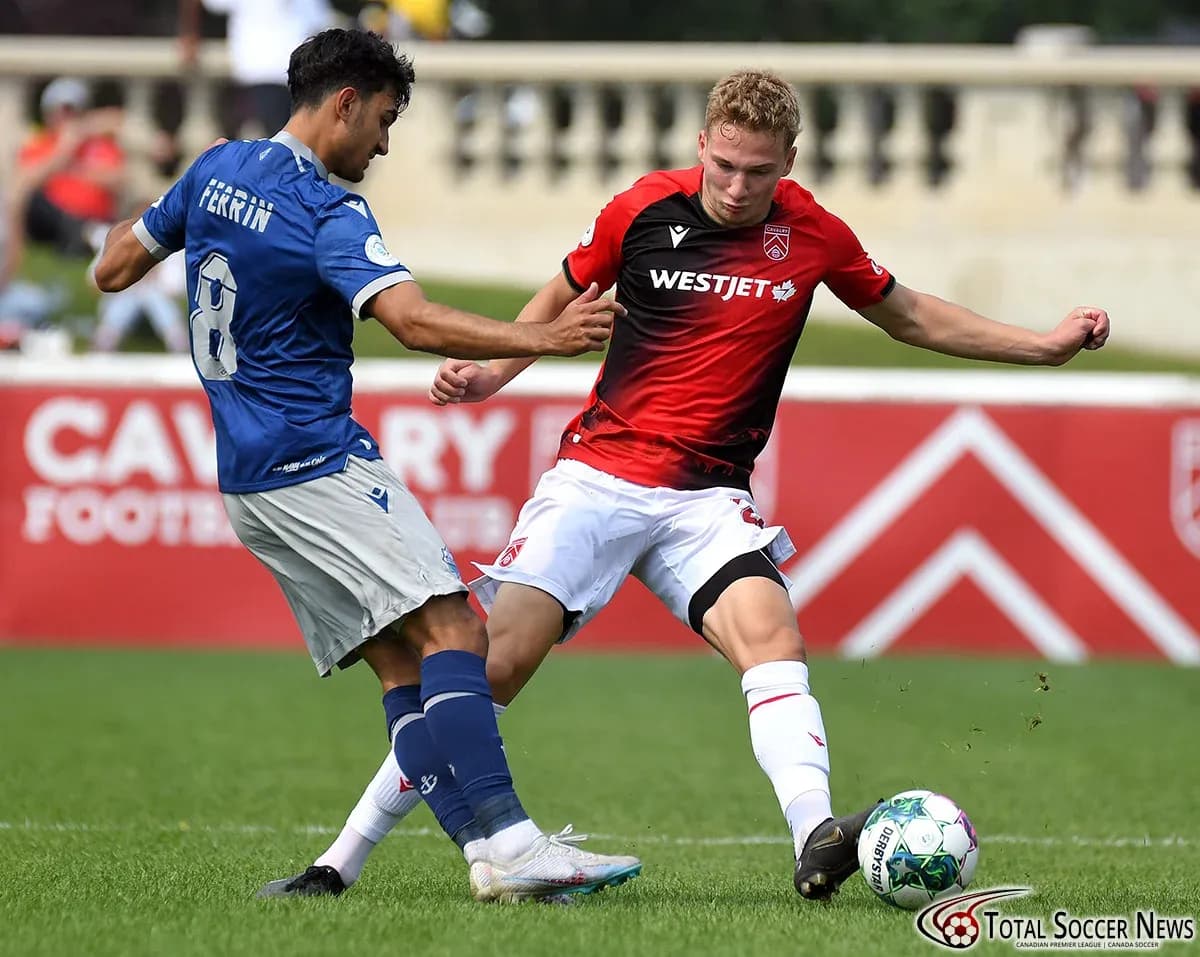 Cavalry FC player tackling HFX Wanderers FC opponent