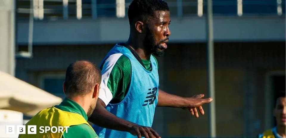 Player training on the field with teammates nearby