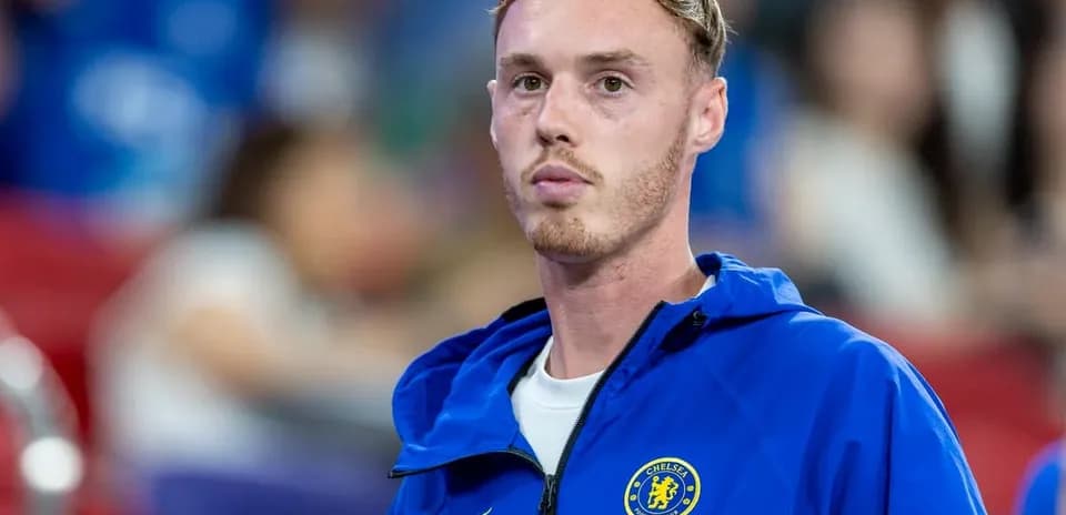 Player in Chelsea FC training jacket on sidelines