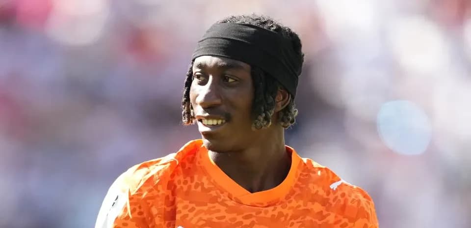 Goalkeeper in orange jersey during a match