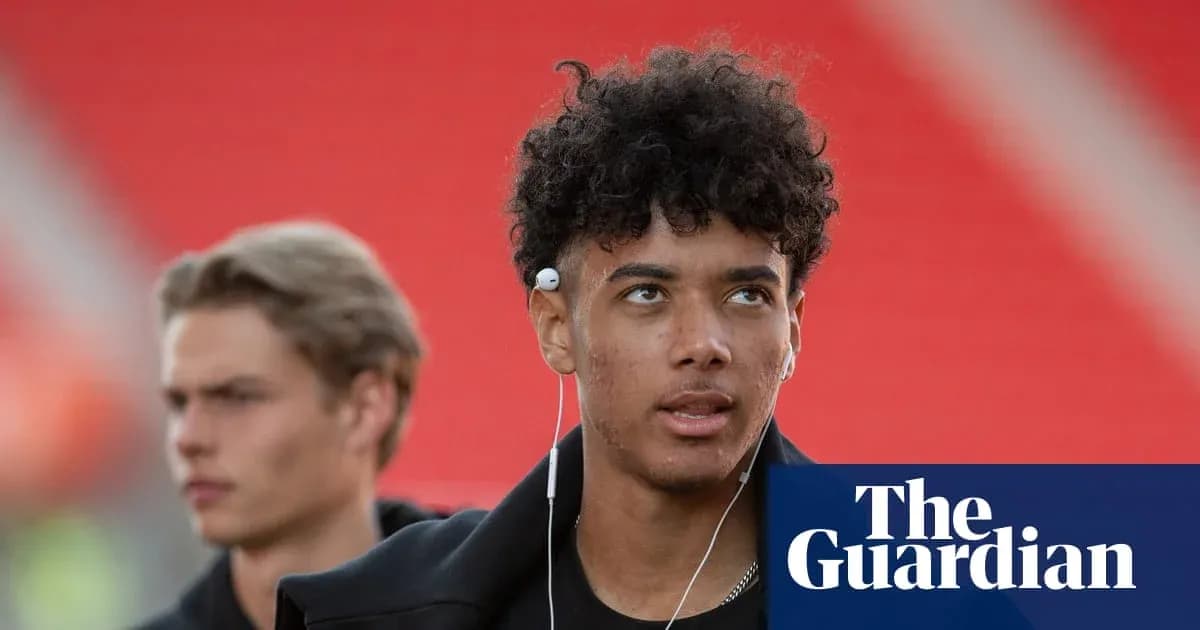 Two young men walking with earbuds in stadium