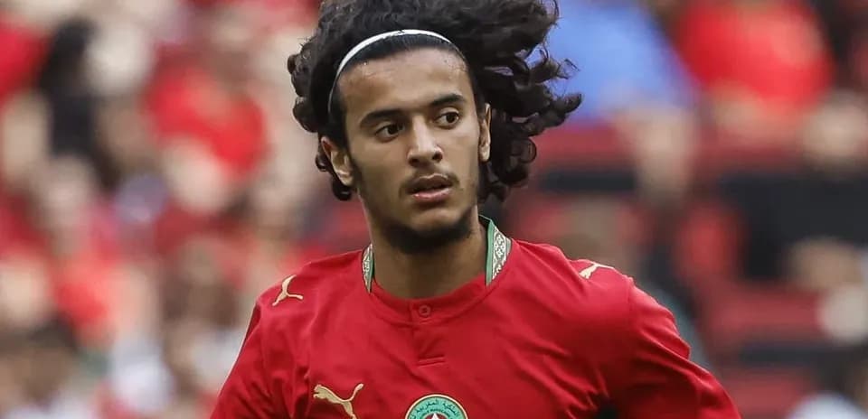 Player in red Morocco jersey running on field