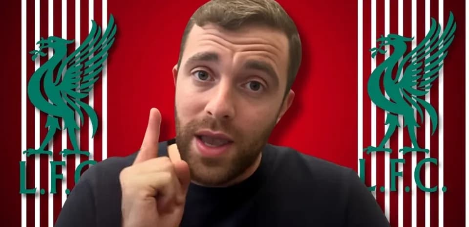 Person speaking with Liverpool FC logos in background