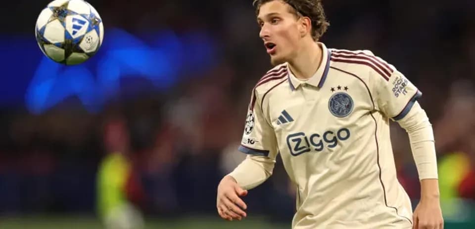Player in Ajax jersey controlling the ball during match