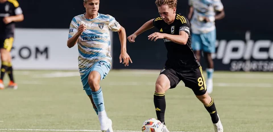 Players competing for the ball during MLS Next Pro match