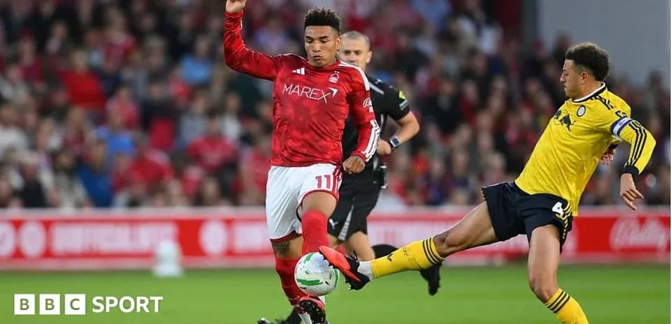 Player in red evading a tackle during match