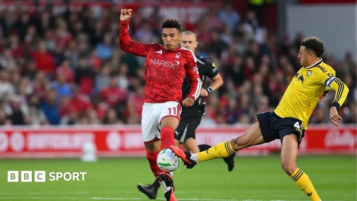 Player in red evading a tackle during match