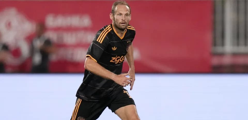 Player in black jersey running on the pitch