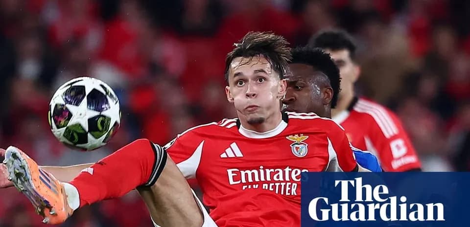 Benfica player striking the ball during match action