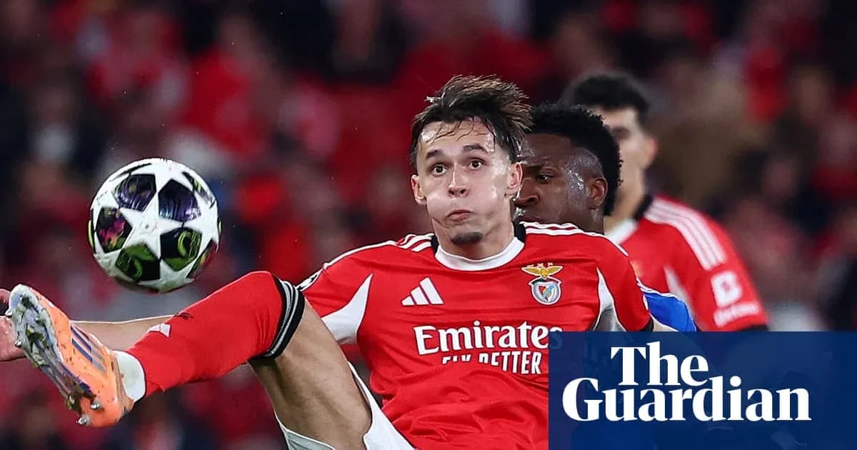 Benfica player striking the ball during match action
