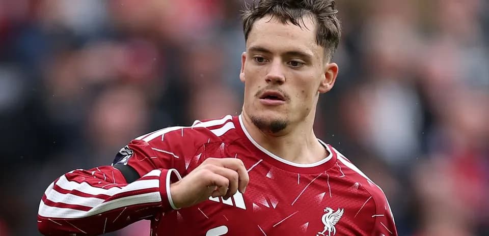 Player in Liverpool kit gesturing during match