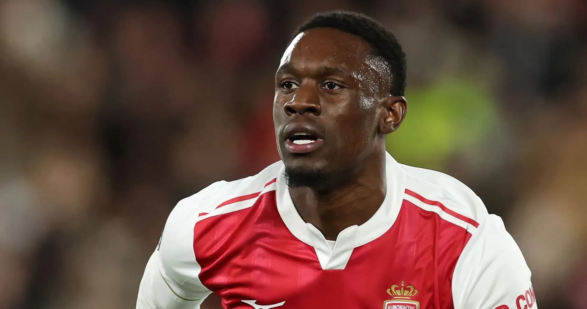 Player running during a football match in Monaco kit
