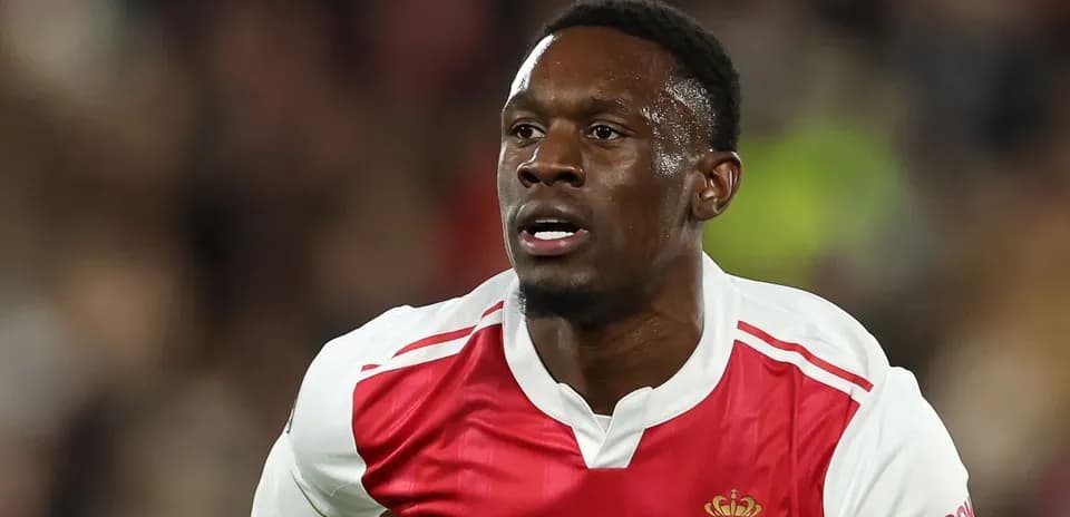 Player running during a football match in Monaco kit