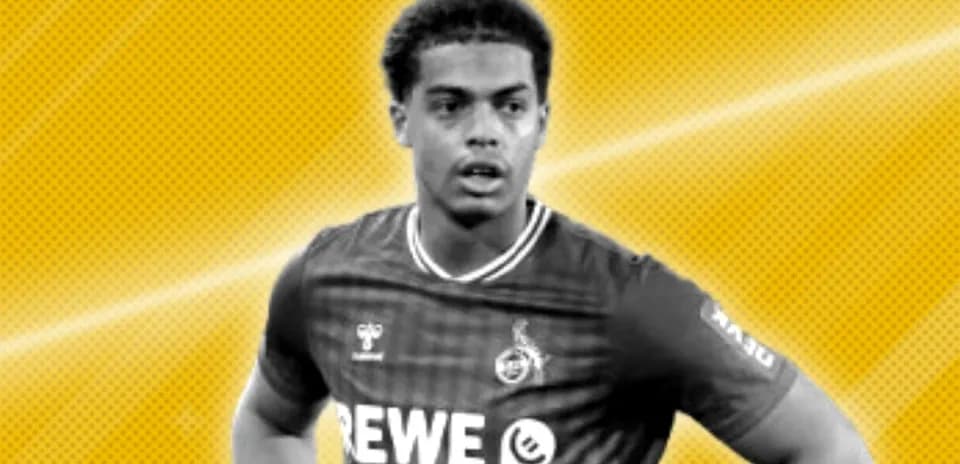 Player in REWE jersey posing against yellow background
