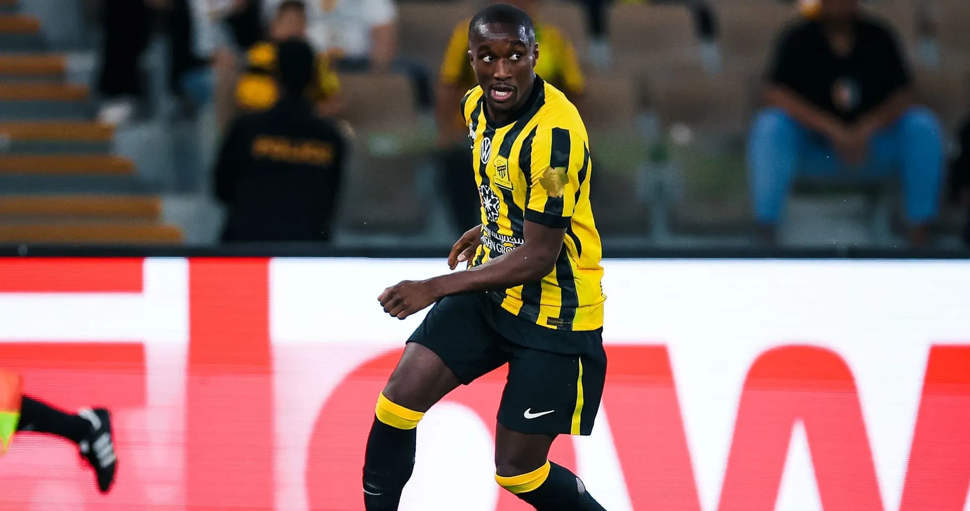 Player in yellow and black uniform during match
