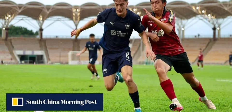 Player dribbling the ball while being challenged