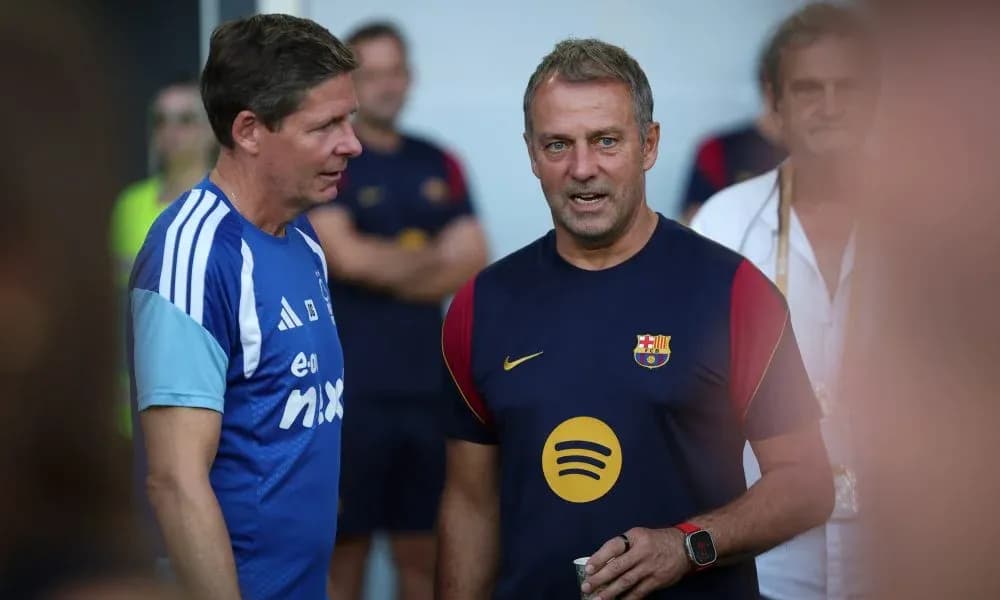 Coaches discussing during Barcelona training session