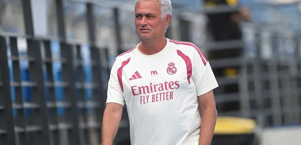 Coach walking on training pitch in team apparel