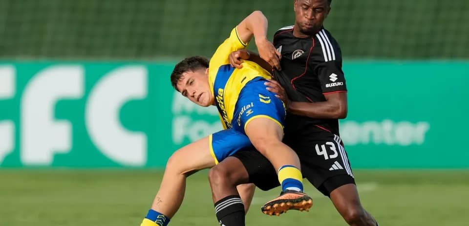Two players battling for the ball during match