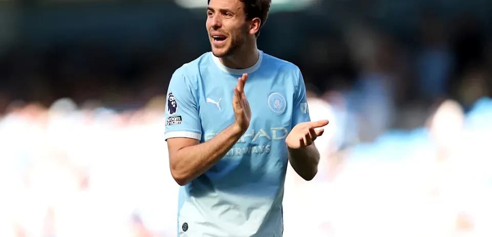 Player in light blue jersey applauding fans