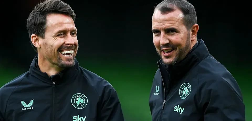Two coaches smiling during a training session
