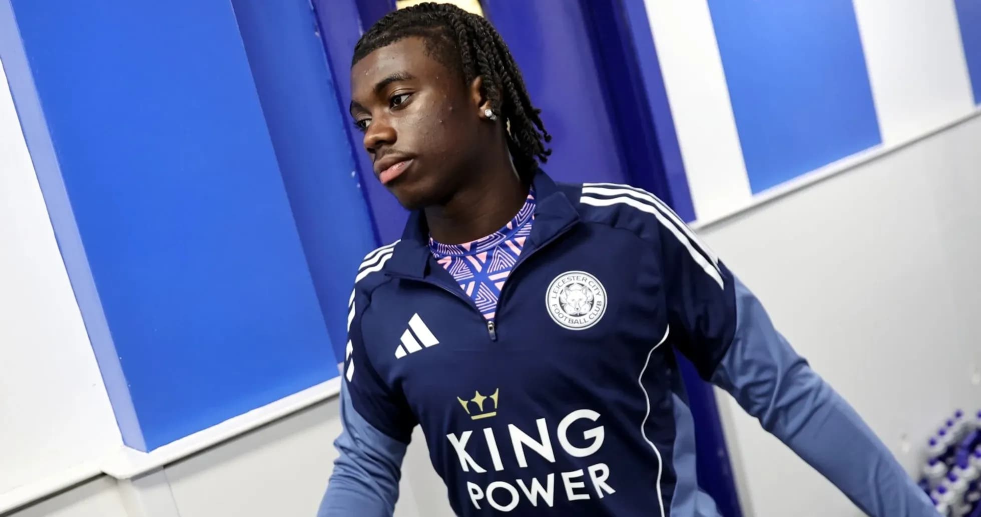 Player wearing Leicester City training gear in hallway