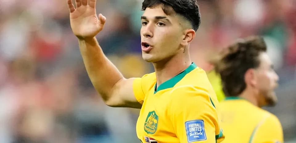 Player gesturing during a football match in yellow kit