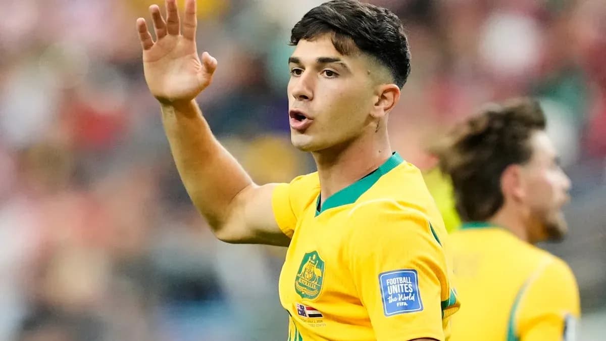 Player gesturing during a football match in yellow kit