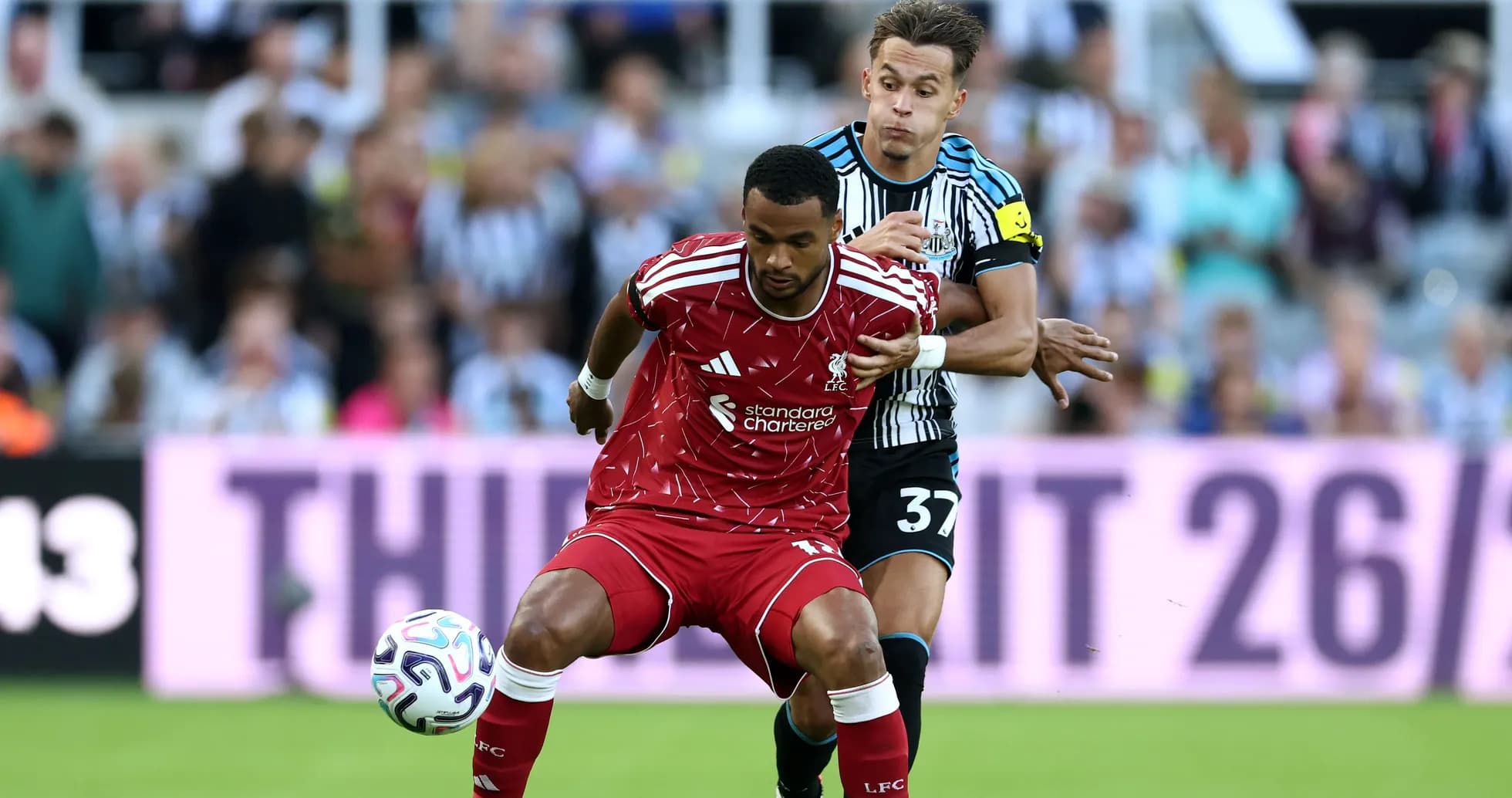 Liverpool player tackled by Newcastle opponent during match