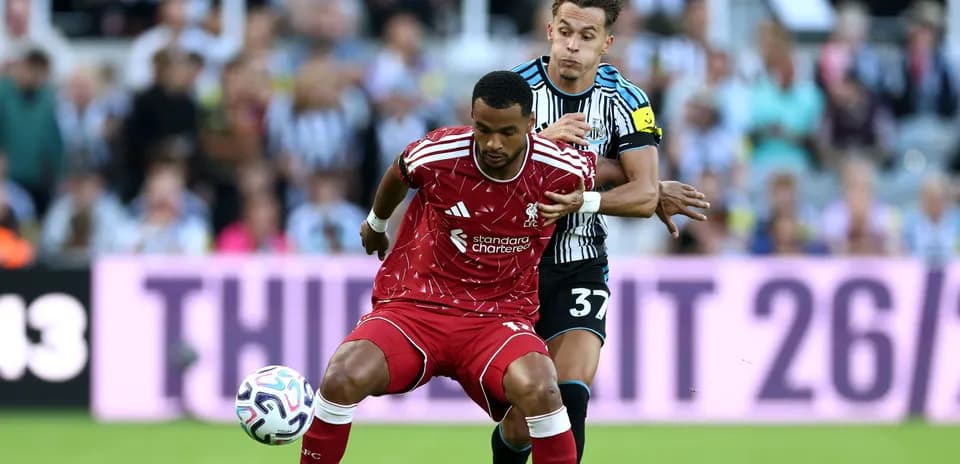 Liverpool player tackled by Newcastle opponent during match
