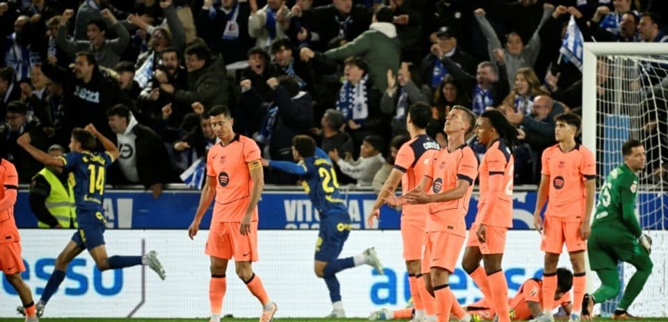 Players reacting as fans celebrate a goal