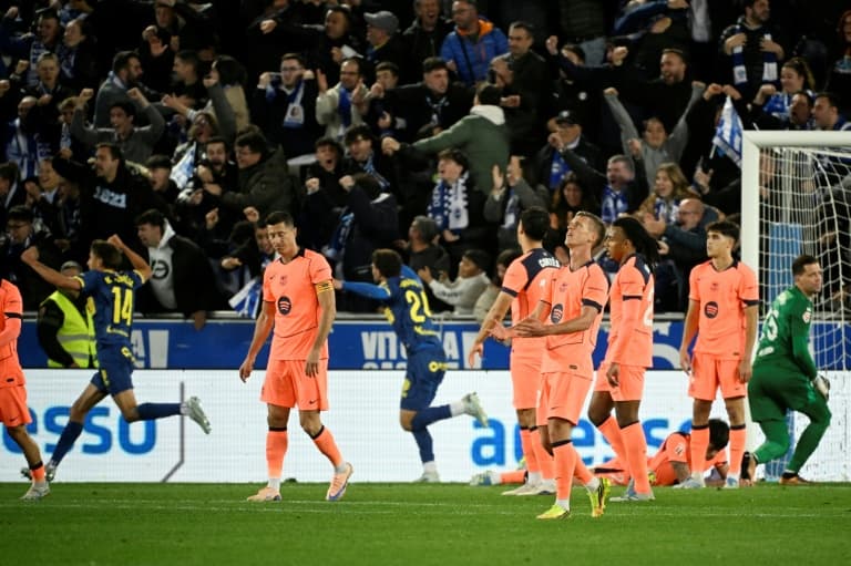 Players reacting as fans celebrate a goal