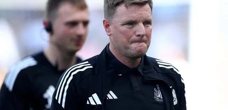 Manager walking off pitch with staff member