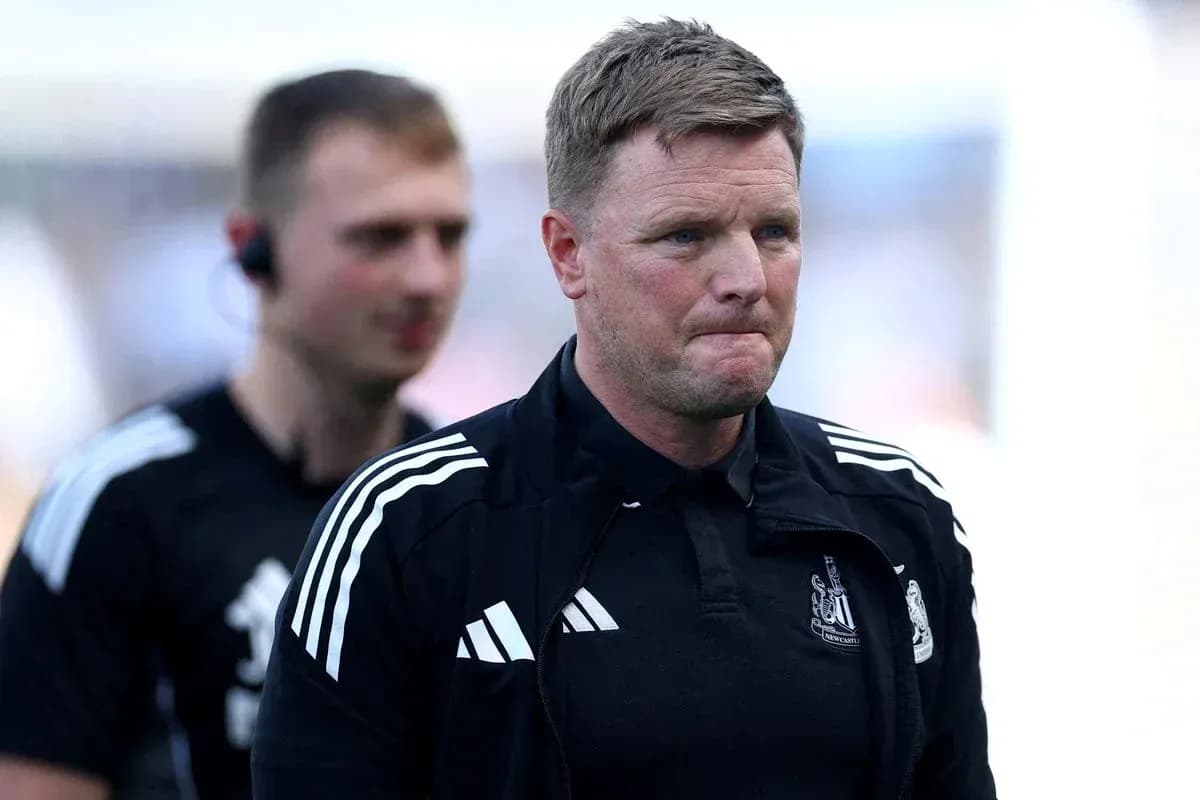 Manager walking off pitch with staff member