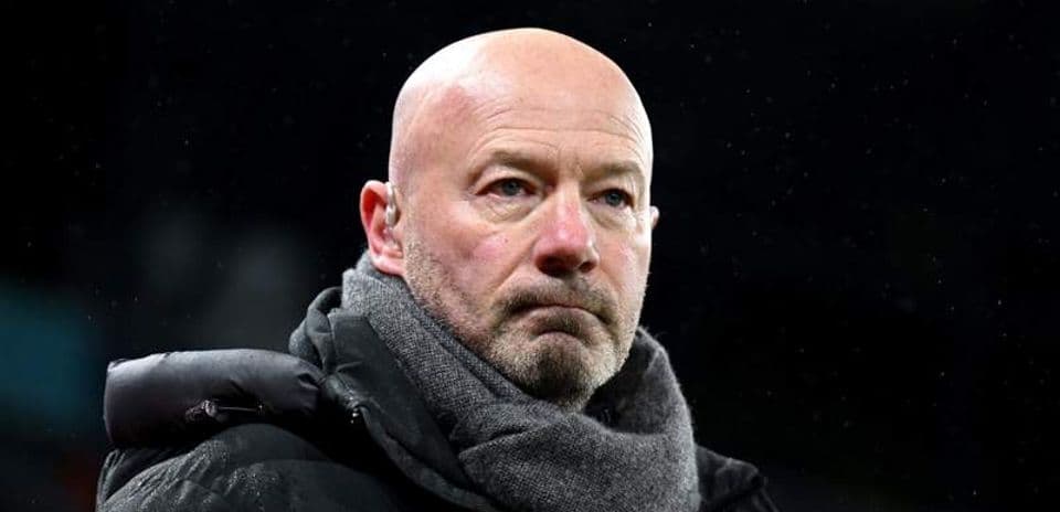 Man wearing a coat and scarf at a match