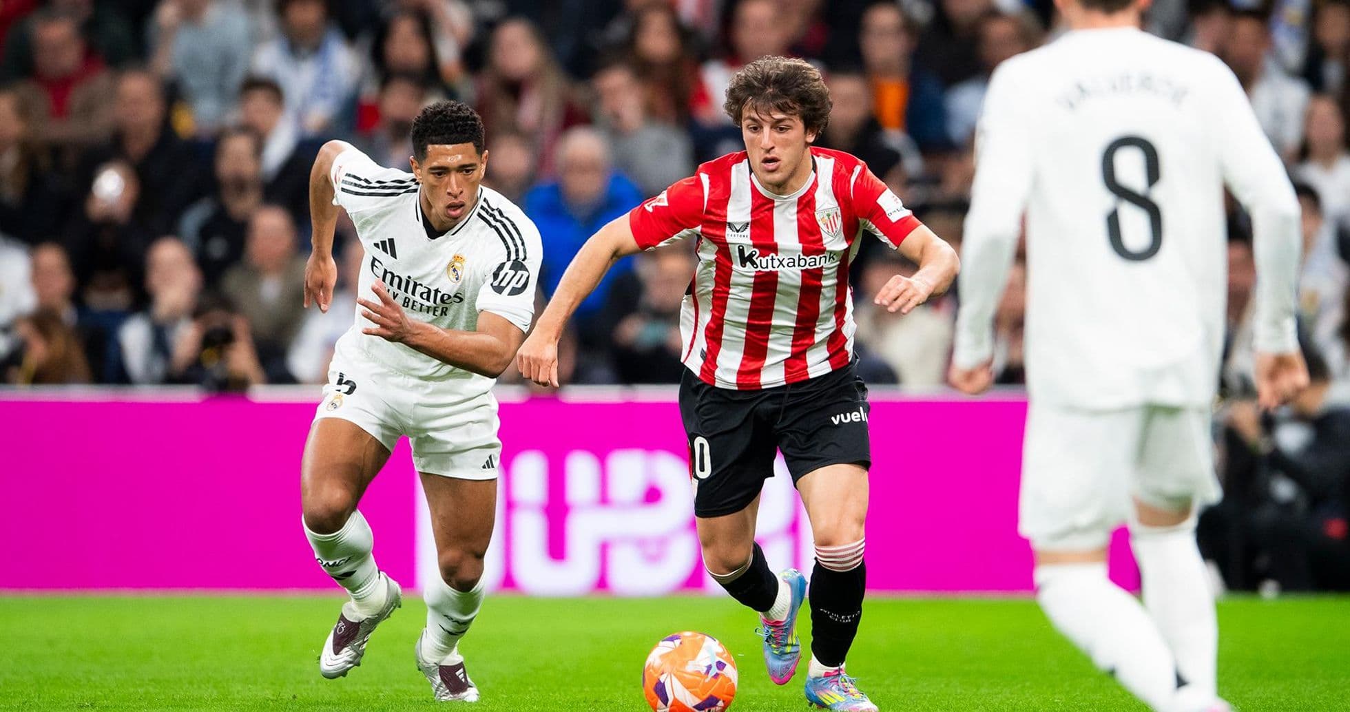 Real Madrid player chasing Athletic Club opponent