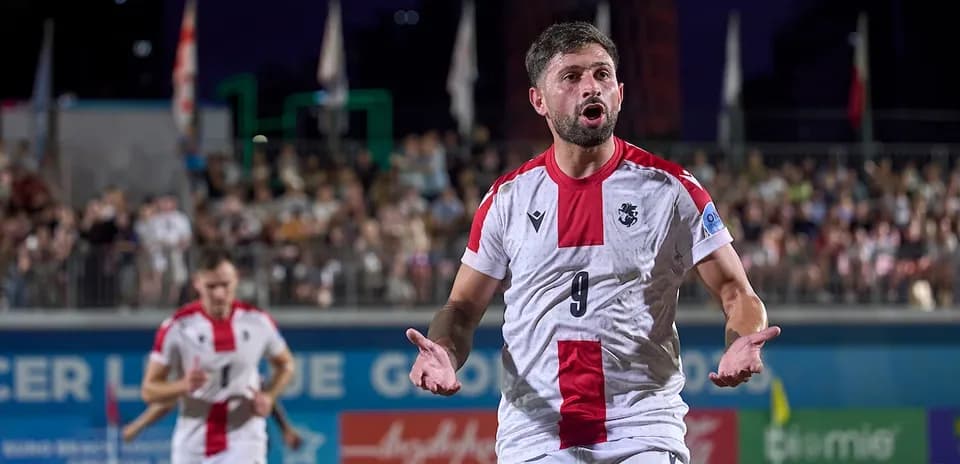 Player gesturing during beach soccer match