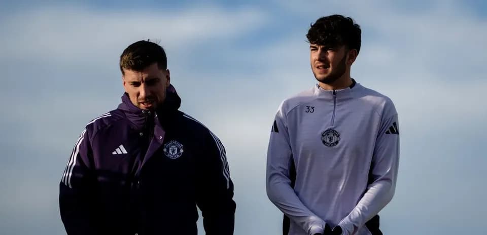 Two Manchester United players walking together outdoors