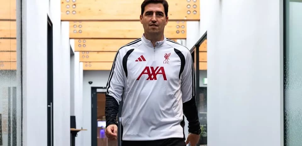 Player walking in Liverpool training facility corridor