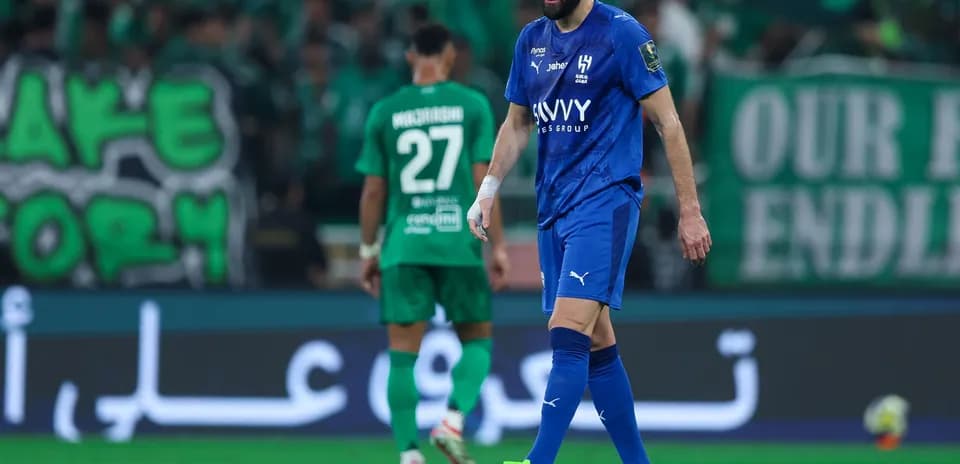 Player in blue kit walking on the pitch